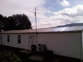 New metal roof on a single wide mobile home with a TV antenna in Cottonwood